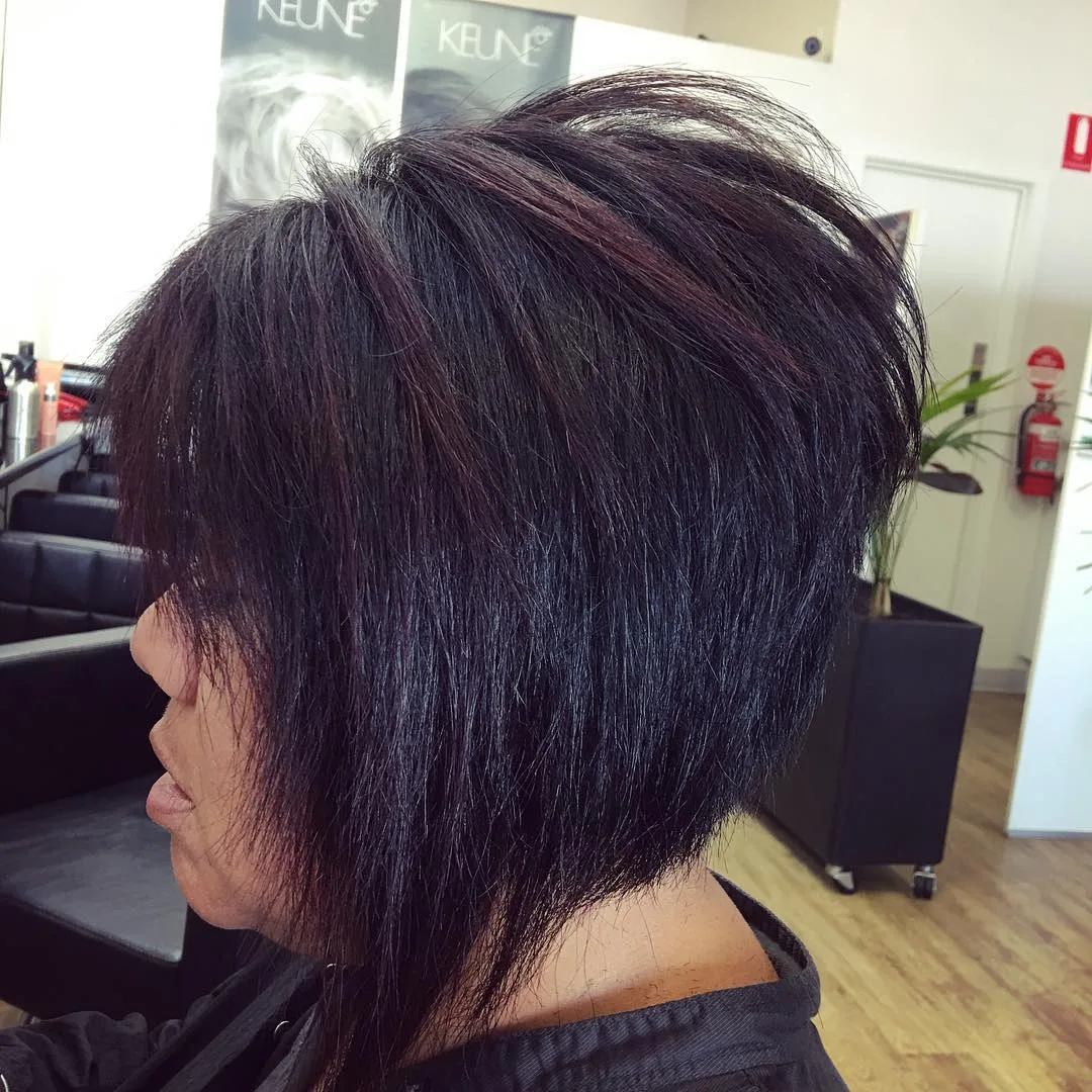 Sharp dark angled bob, side profile, finished at Jolin's Hair Design